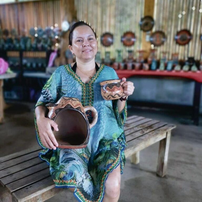 Artisan holding hand-painted Costa Rican pottery on a cultural tour at Rincón de la Vieja