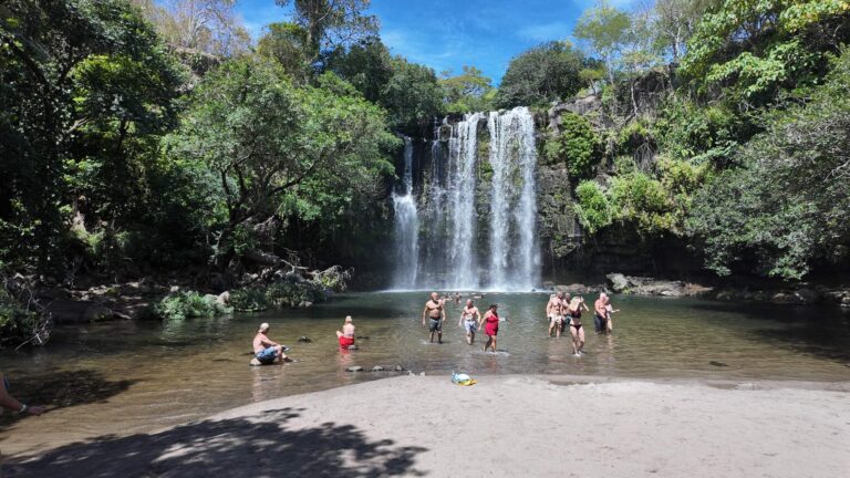 Sandy beach and natural pool at the base of Llanos de Cortés Waterfall, Guanacaste, Costa Rica