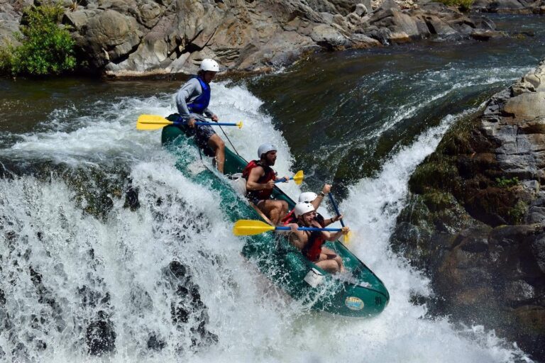 Raft with guests and guide dropping over a waterfall on the Tenorio River, Guanacaste, Costa Rica