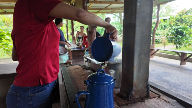 Hot water poured from a blue enamel jug on a wood stove at a coffee farm near Bijagua, Costa Rica