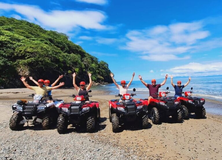 ATV tour group with arms raised on a Pacific beach in Guanacaste, Costa Rica