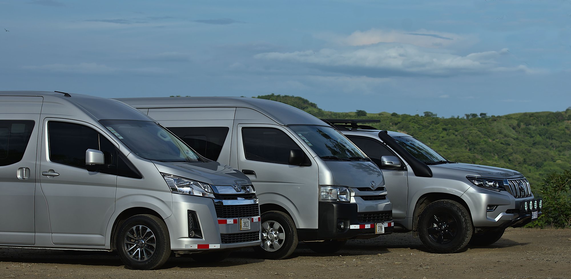 Blue Sky Private Tours vehicle fleet: two Toyota Hiace vans and a Land Cruiser Prado