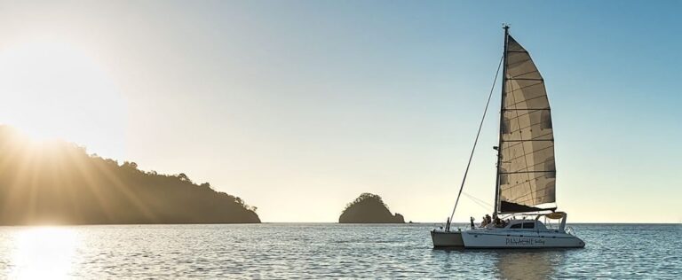 Catamaran under sail at sunset beside a small island off the Guanacaste coast, Costa Rica