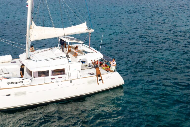 Guest diving off the side of the catamaran into the Pacific Ocean in Guanacaste, Costa Rica