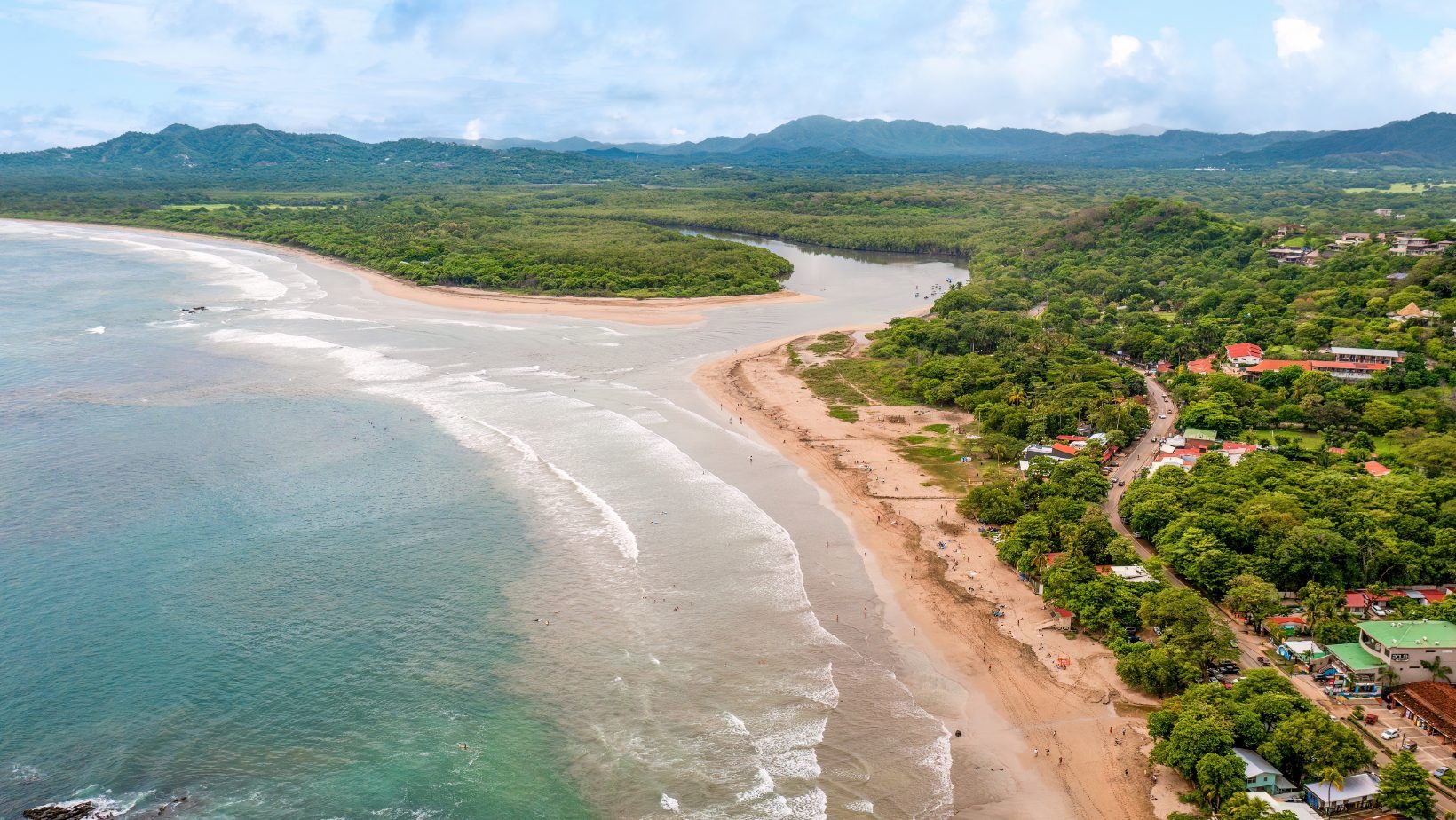 Aerial view of Tamarindo Beach with the estuary and mangroves at the north end