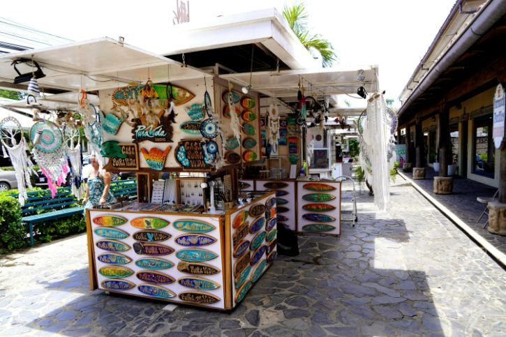 Souvenir stand with painted wooden signs and handicrafts in Tamarindo