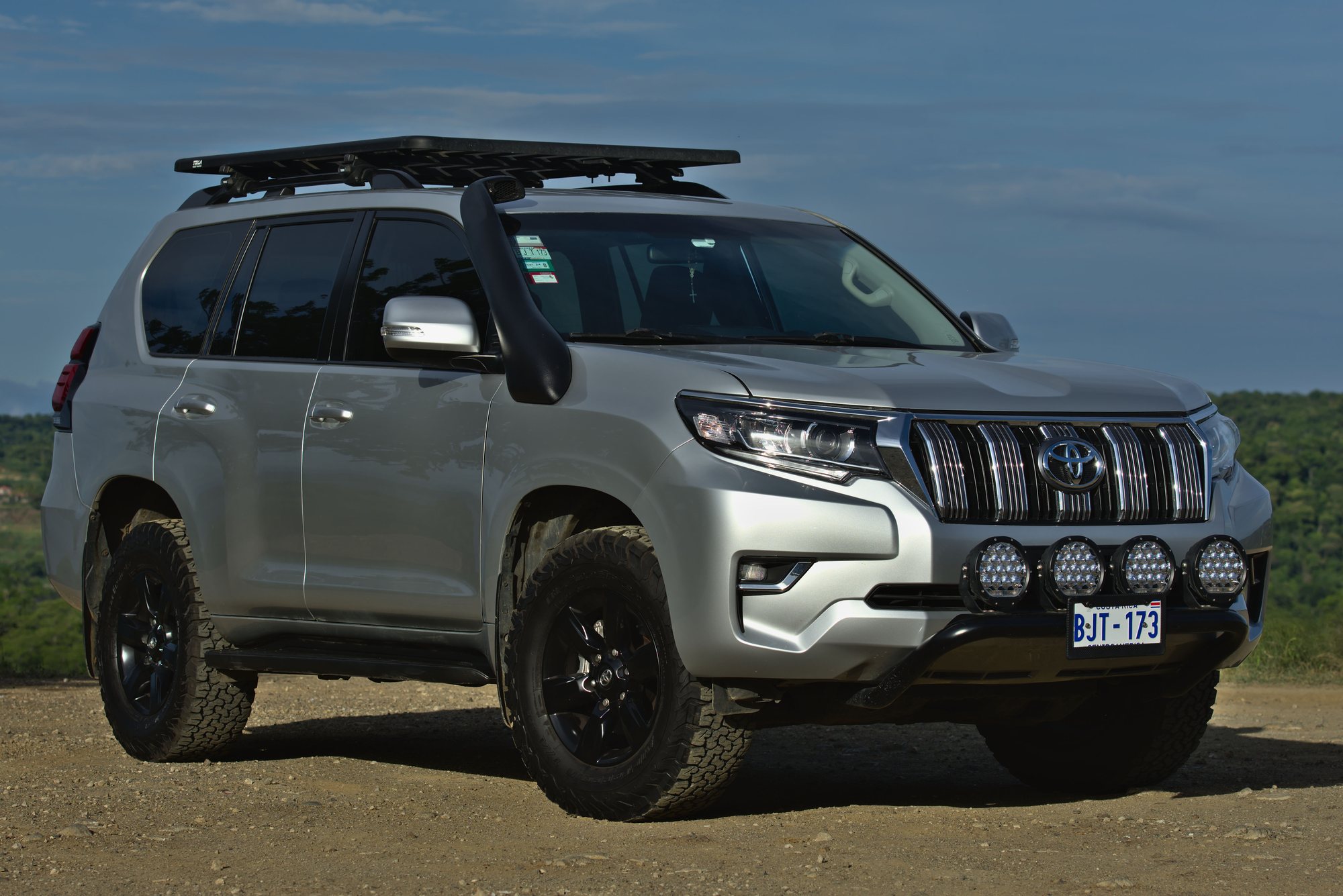 Silver Toyota Land Cruiser Prado 4x4 with roof rack for private transfers in Guanacaste